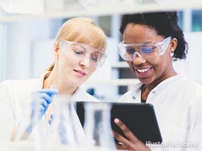 Two lab technicians looking at touch screen device 
